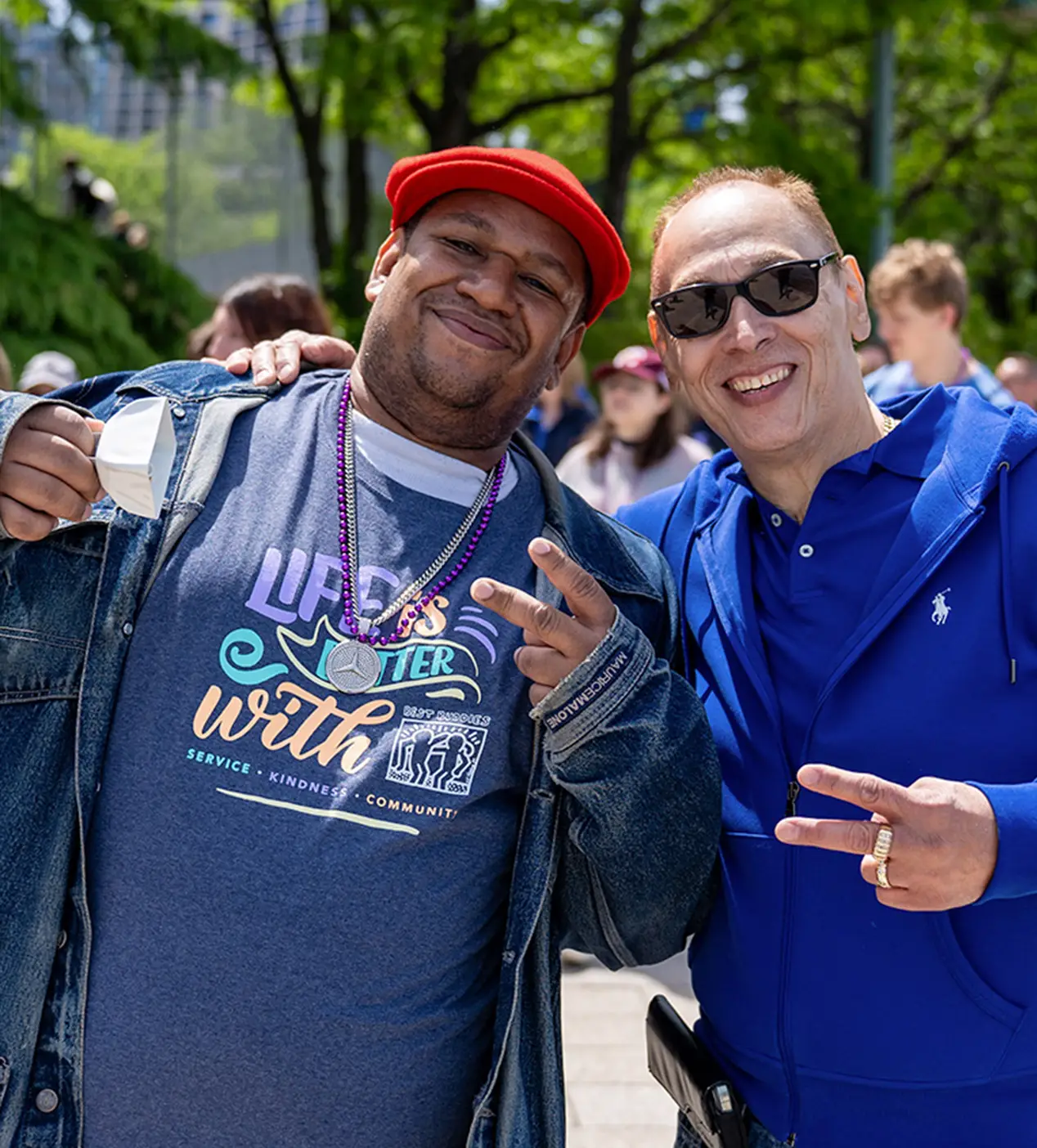 Two event participants flashing peace handsigns